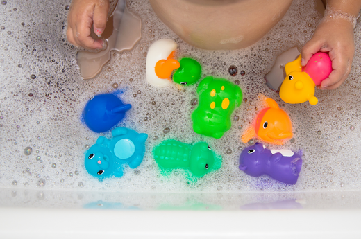 Colorful rubber toys floating in the bathtub | ACE DECOR