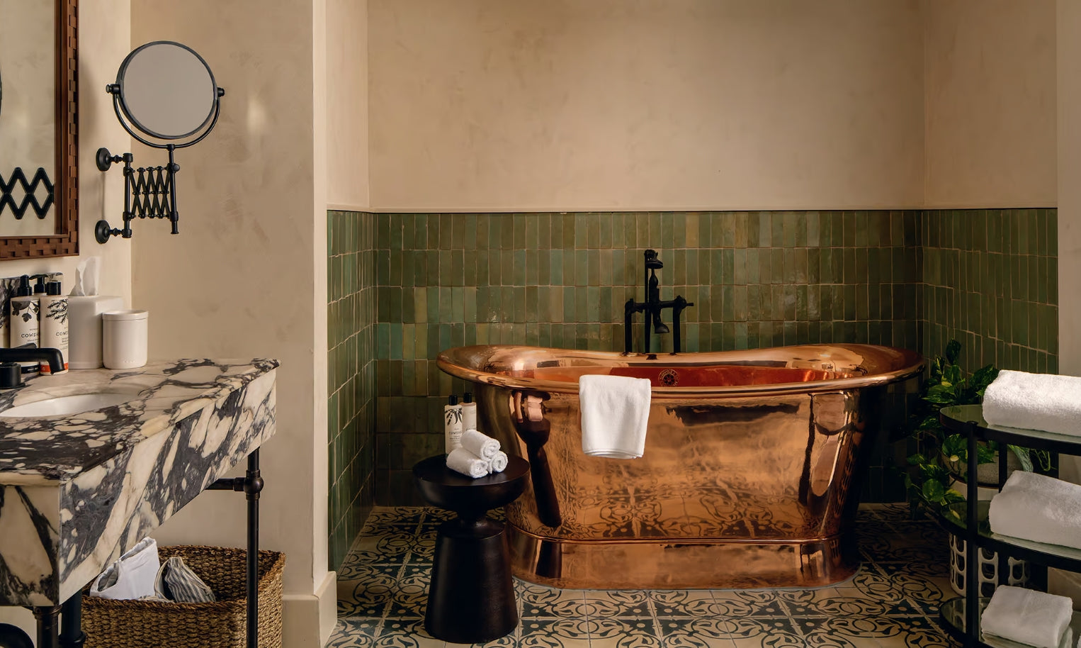 Luxury copper deep bathtubs in spa-like bathroom with green tiles and marble vanity