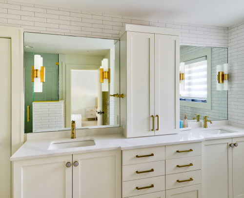 A modern double vanity setup featuring a rectangular frameless LED bathroom mirror, accented by gold fixtures and wall-mounted sconces. | ACE DECOR