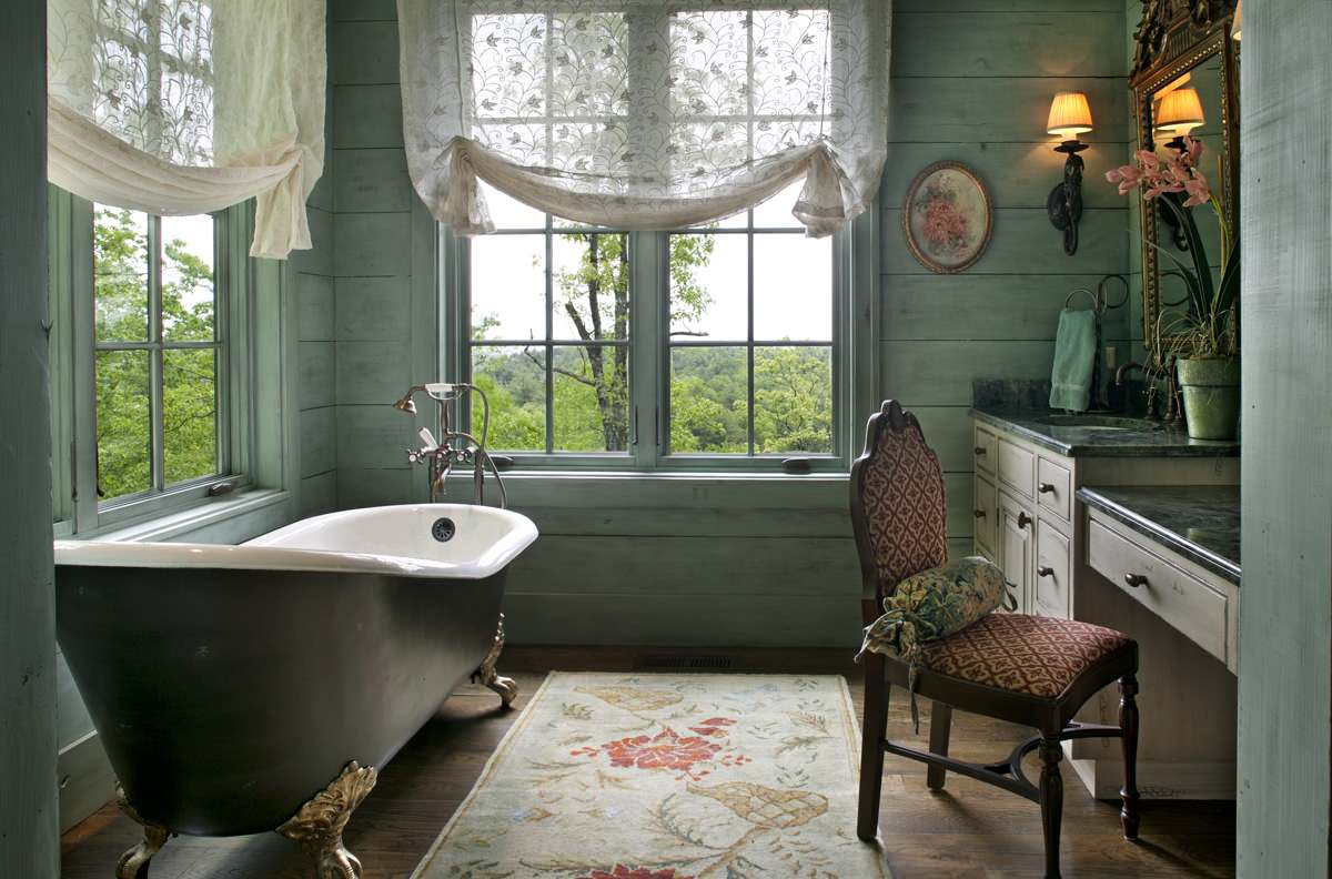 A cozy vintage bathroom featuring a clawfoot bathtub with an elegant clawfoot bathtub faucet under soft natural light. | ACE DECOR