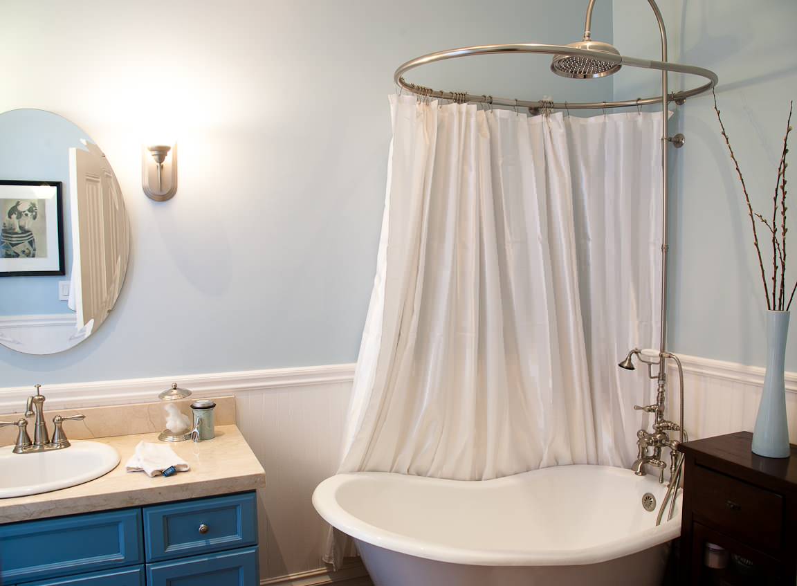 A serene bathroom featuring elegant shower curtains for clawfoot bathtubs, styled with a classic oval curtain rod and soft neutral tones. | ACE DECOR