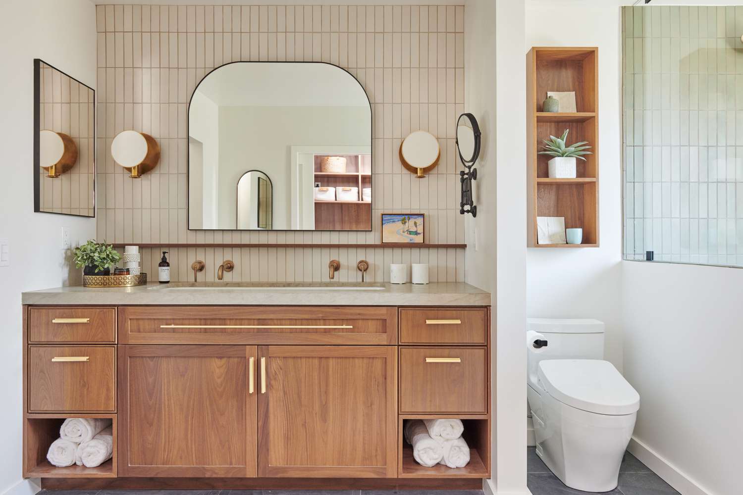a stylish bathroom his and her vanities setup featuring a warm wood vanity with gold hardware, dual faucets, elegant lighting, and thoughtful storage solutions. | ACE DECOR