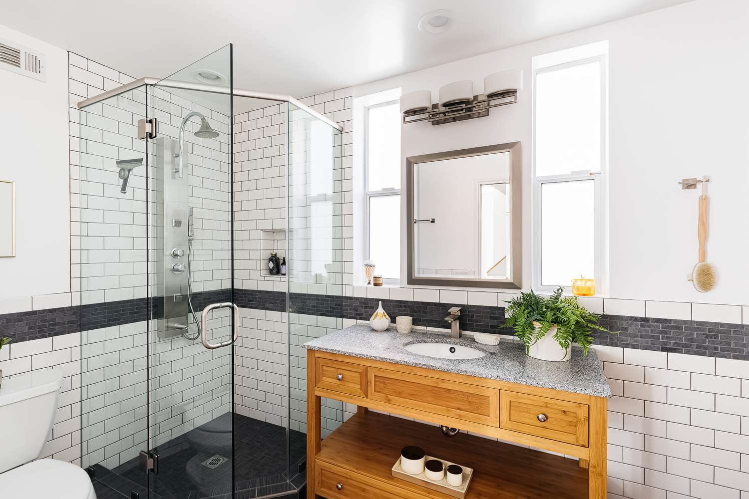 A clean bathroom with a framed shower enclosure | ACE DECOR