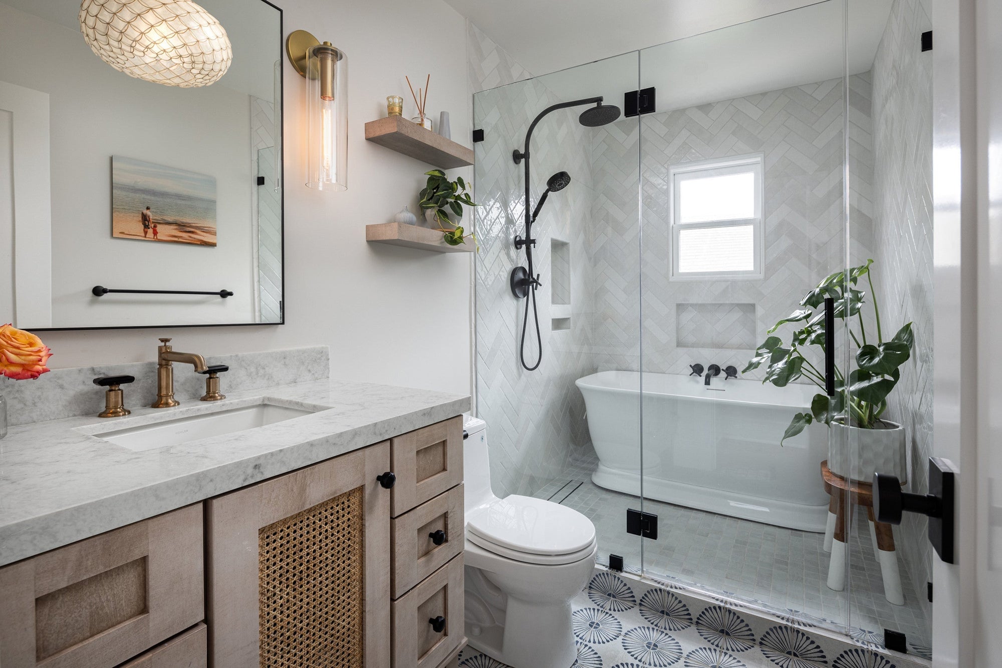 A stylish modern bathroom featuring a freestanding tub, glass-enclosed shower, and a natural wood vanity with a marble top and brass faucet. | ACE DECOR