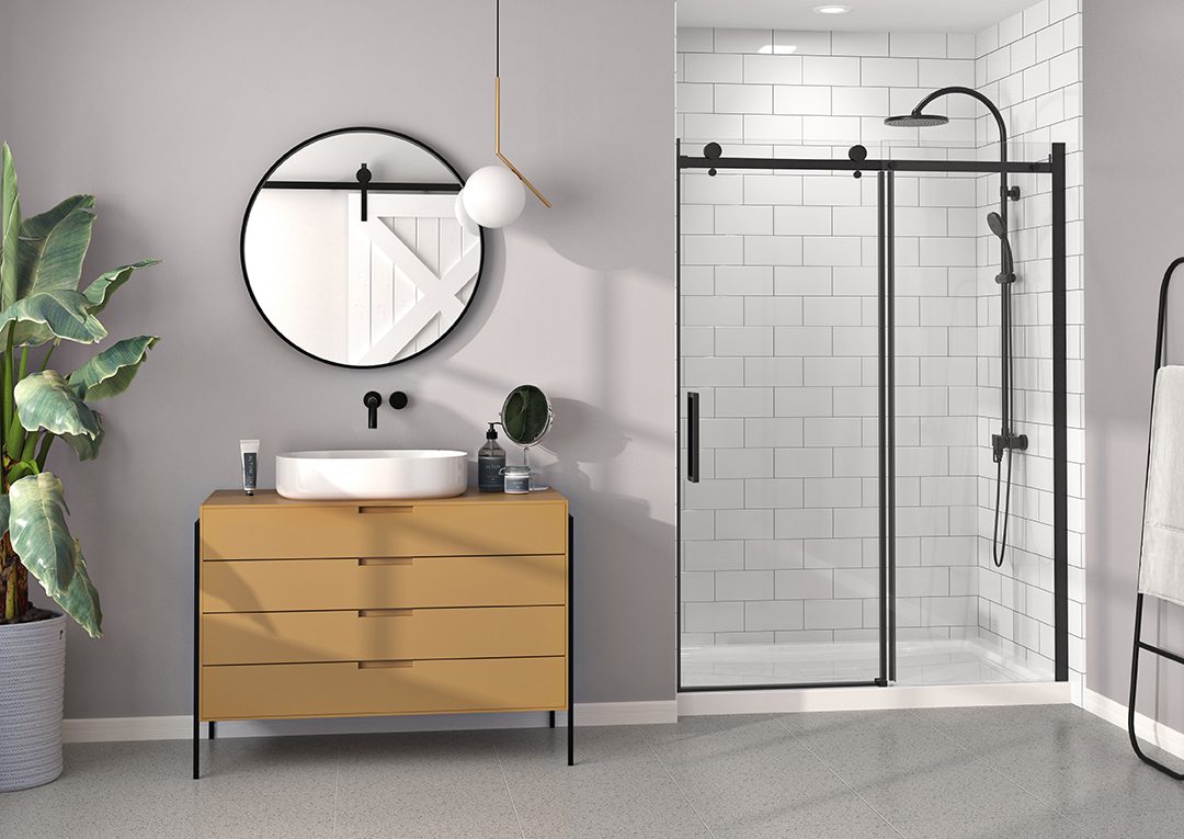 a modern bathroom with sliding glass shower doors, a stylish sink, and a large round mirror. | ACE DECOR