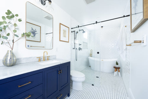 a bright, modern bathroom featuring frameless tub shower doors enclosing a freestanding bathtub and black matte fixtures. | ACE DECOR