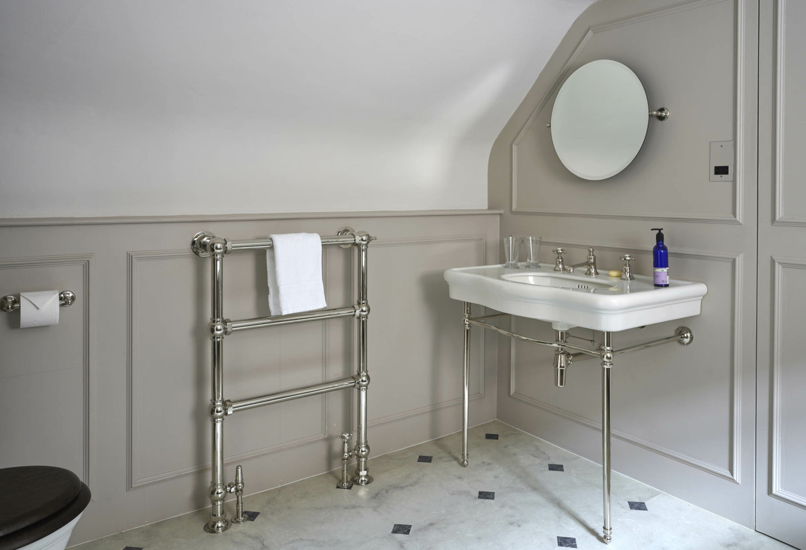 an elegant bathroom with a vintage-style sink, towel rack, and a clean, minimalistic design featuring neutral-colored walls and floors. | ACE DECOR