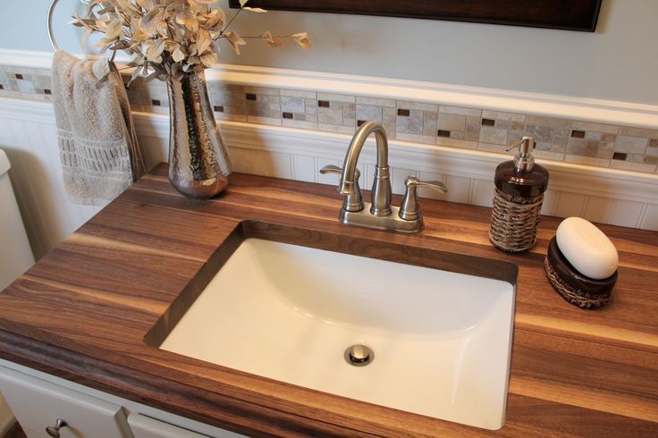 A beautifully styled butcher block for bathroom vanity featuring a sleek undermount sink, brushed nickel faucet, and warm decorative accents. | ACE DECOR