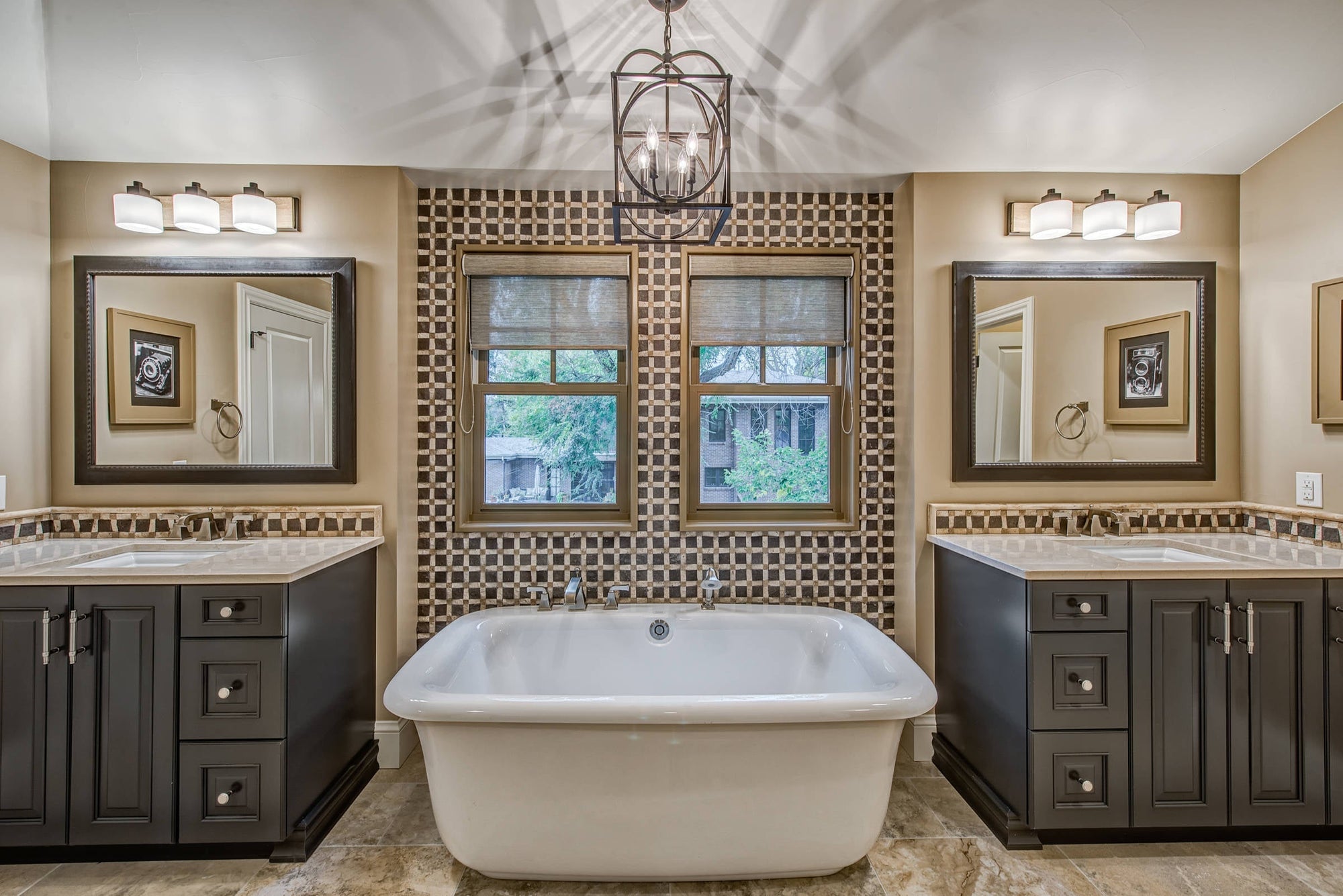 This is a beautifully designed bathroom featuring a spacious acrylic soaking bathtub centered between two elegant vanity sinks with large mirrors. | ACE DECOR