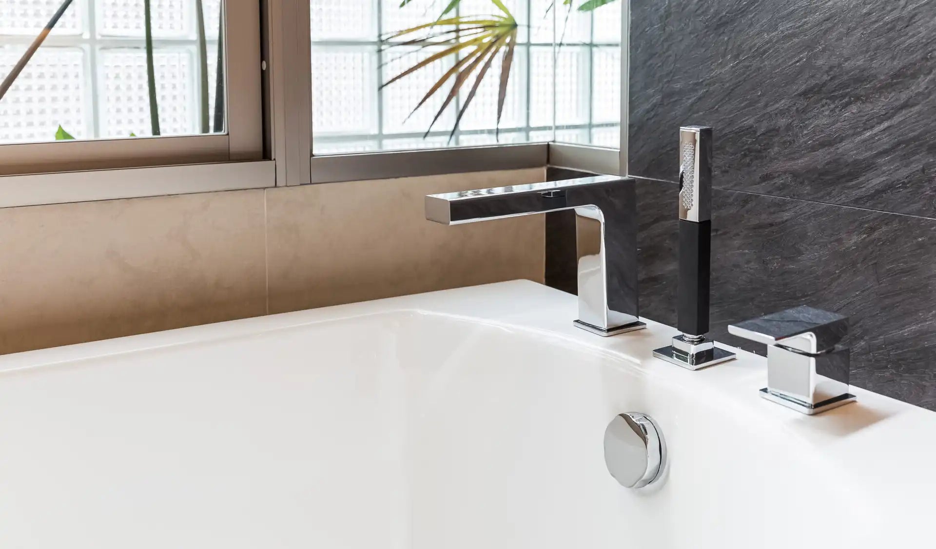 Chrome deck-mounted bathtub faucet with handheld shower – contemporary style perfect for DIY bathtub faucet replacement.