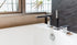 Chrome deck-mounted bathtub faucet with handheld shower – contemporary style perfect for DIY bathtub faucet replacement.