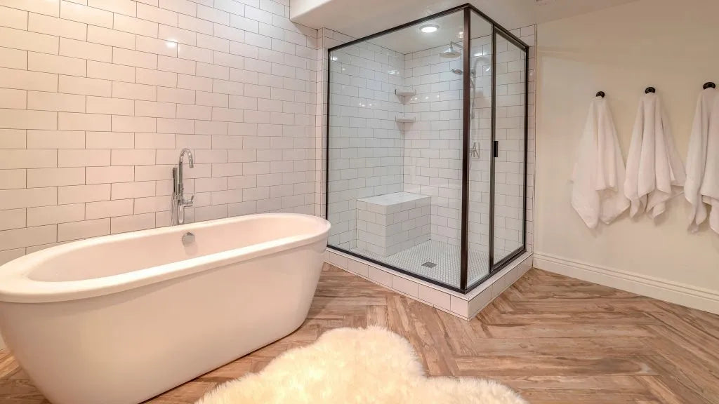 Modern bathroom with a black-framed sliding glass door for shower next to a freestanding tub