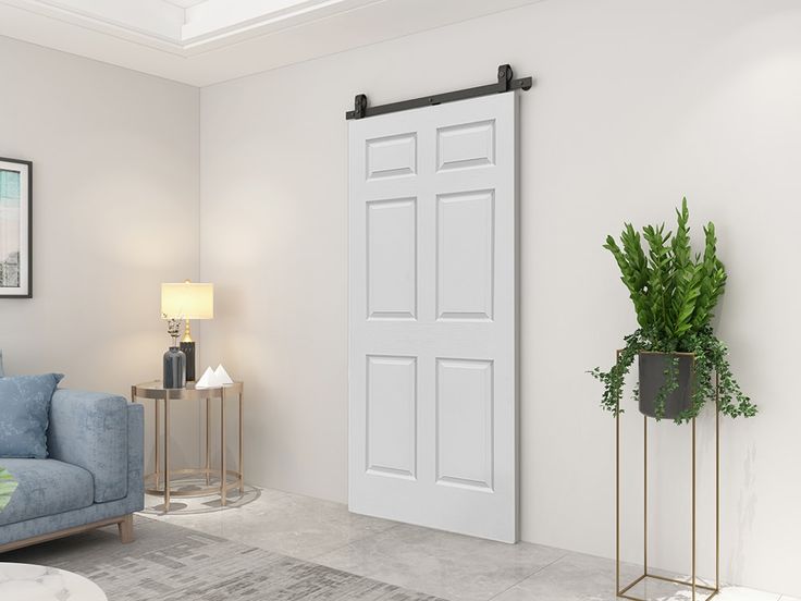 Minimalist solid white inside barn doors installed in a modern living room.