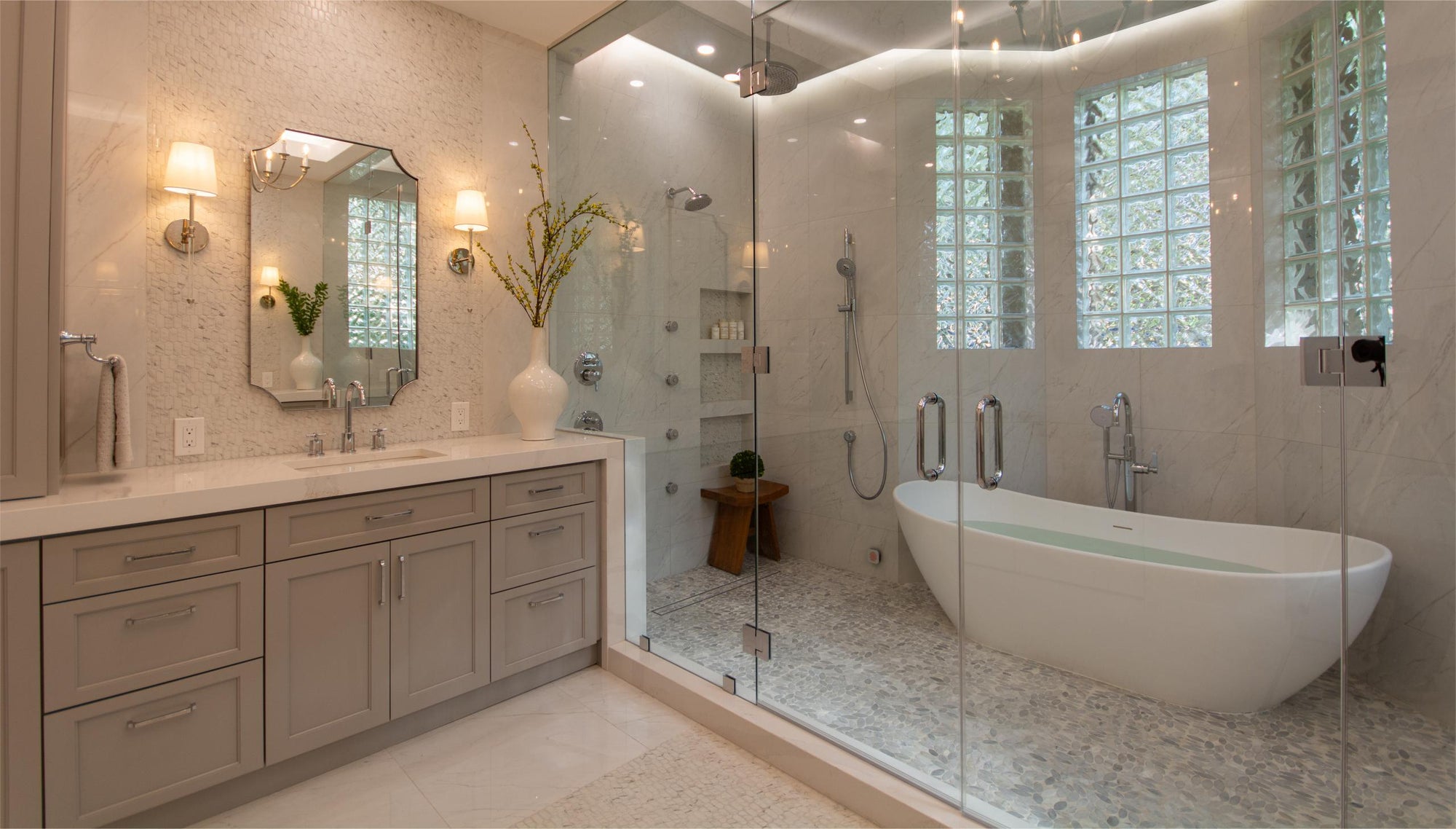 Modern luxury bathroom with freestanding bathtub, marble vanity with storage, glass shower enclosure, neutral palette, natural lighting, spa-like decor