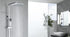 Freestanding chrome best rain shower system in a minimalist modern bathroom with natural light