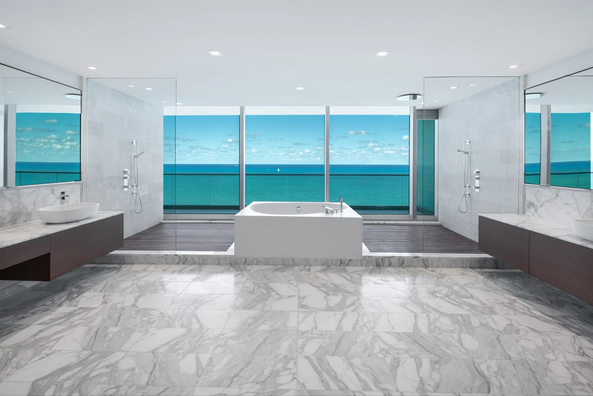 Luxury modern bathroom with ocean-view, marble floors, freestanding tub, and dual spa shower systems in serene setting.