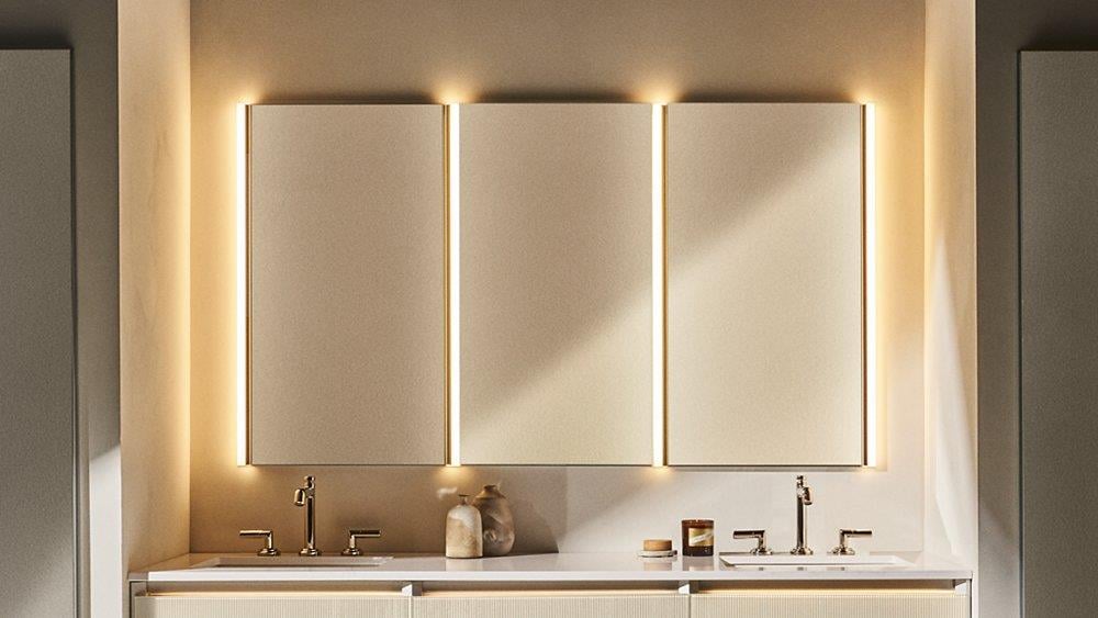 Sleek mirrored medicine cabinet with vertical ambient lights in a dual-sink vanity setup.