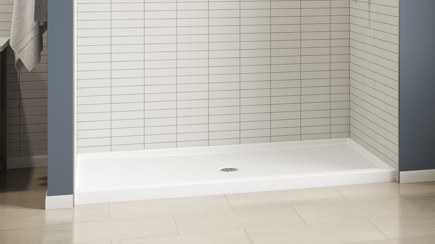 Classic white prefab shower base with center drain in a tiled bathroom.
