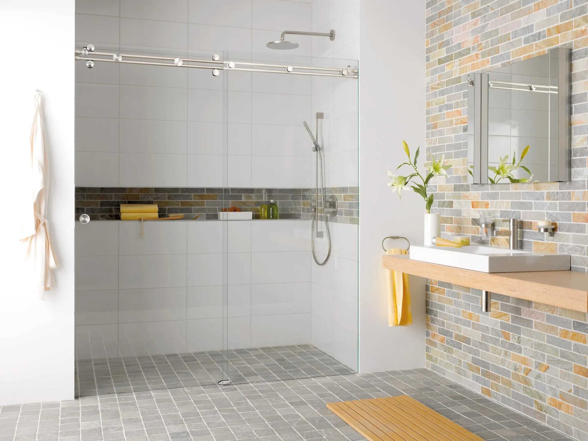 Modern bathroom with frameless shower door, mosaic tile accents and floating vanity.