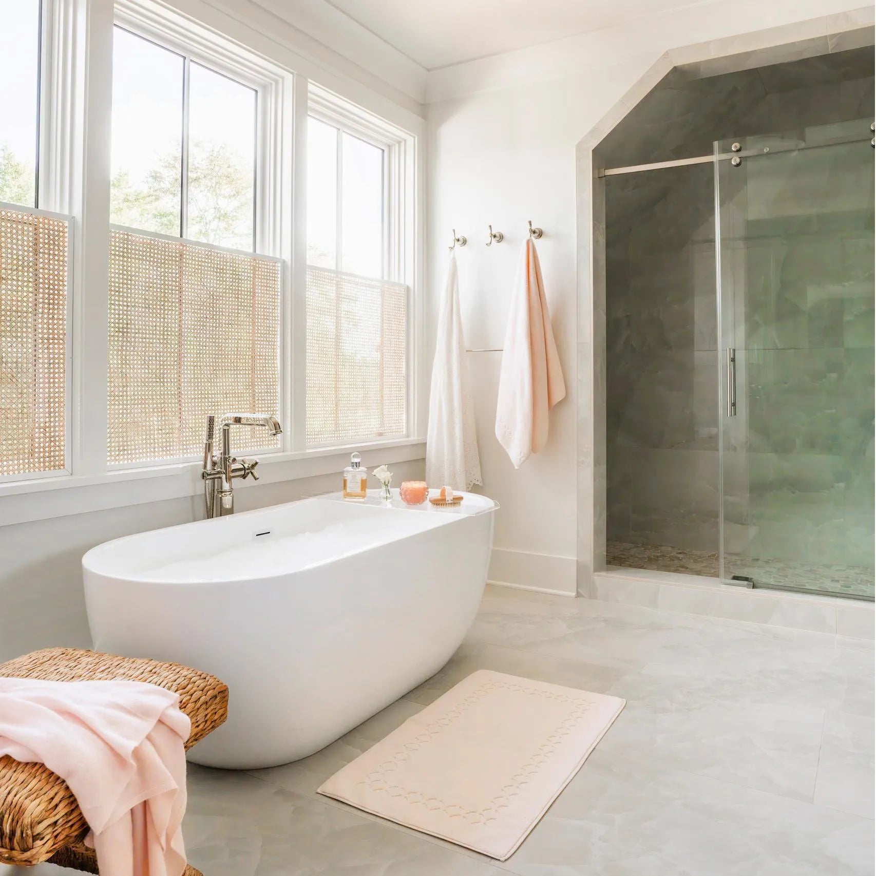Modern minimalist bathroom featuring freestanding bathtub and glass shower door.