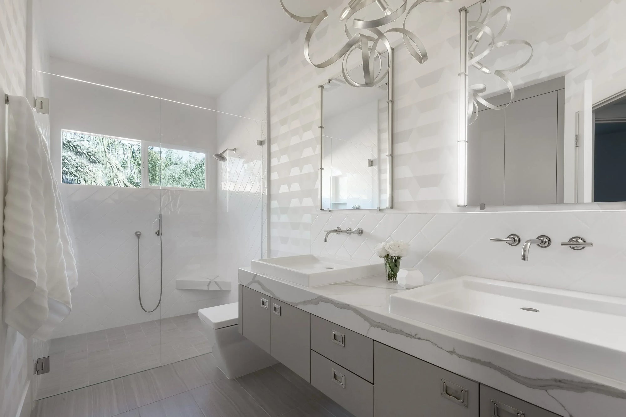 Modern minimalist bathroom featuring a sleek bathroom sink with marble countertop and double vanity.