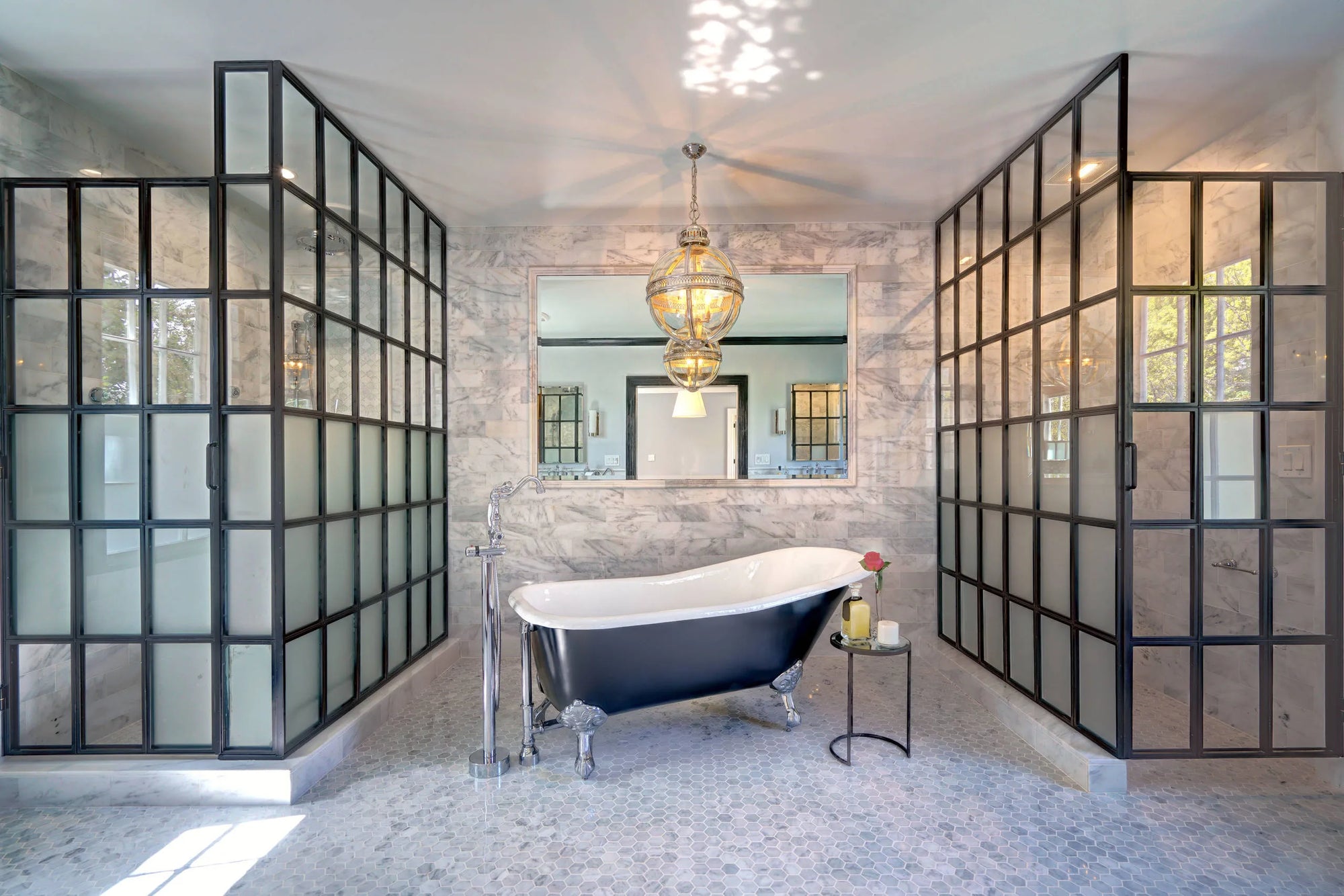 Luxury bathroom featuring a black and white vintage clawfoot bathtub with glass-block partitions.