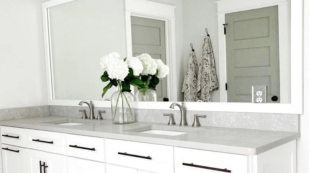 A modern bathroom featuring stick on frames for bathroom mirrors, enhancing the vanity area with a sleek white frame design