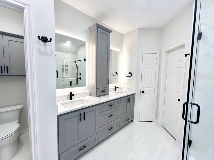 Spacious bathrooms with grey cabinets and double vanity design