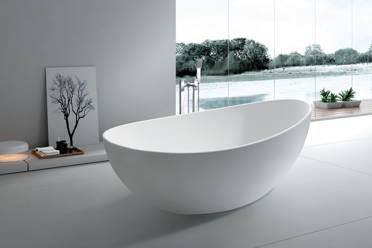 Modern oval soaking tub in minimalist bathroom, a top choice for best material for freestanding bathtub