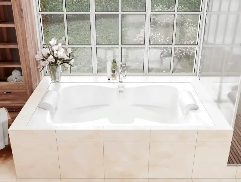Built-in double bathtub with twin headrests by a large glass window