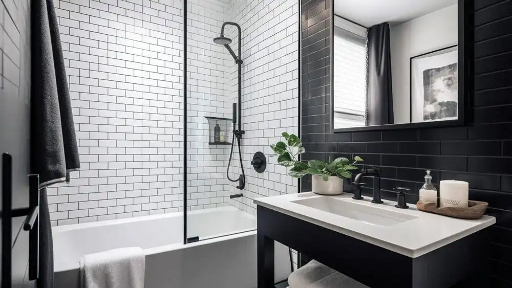 Black and white small bathroom shower ideas featuring a tub-shower combo, frameless glass, and subway tiles.