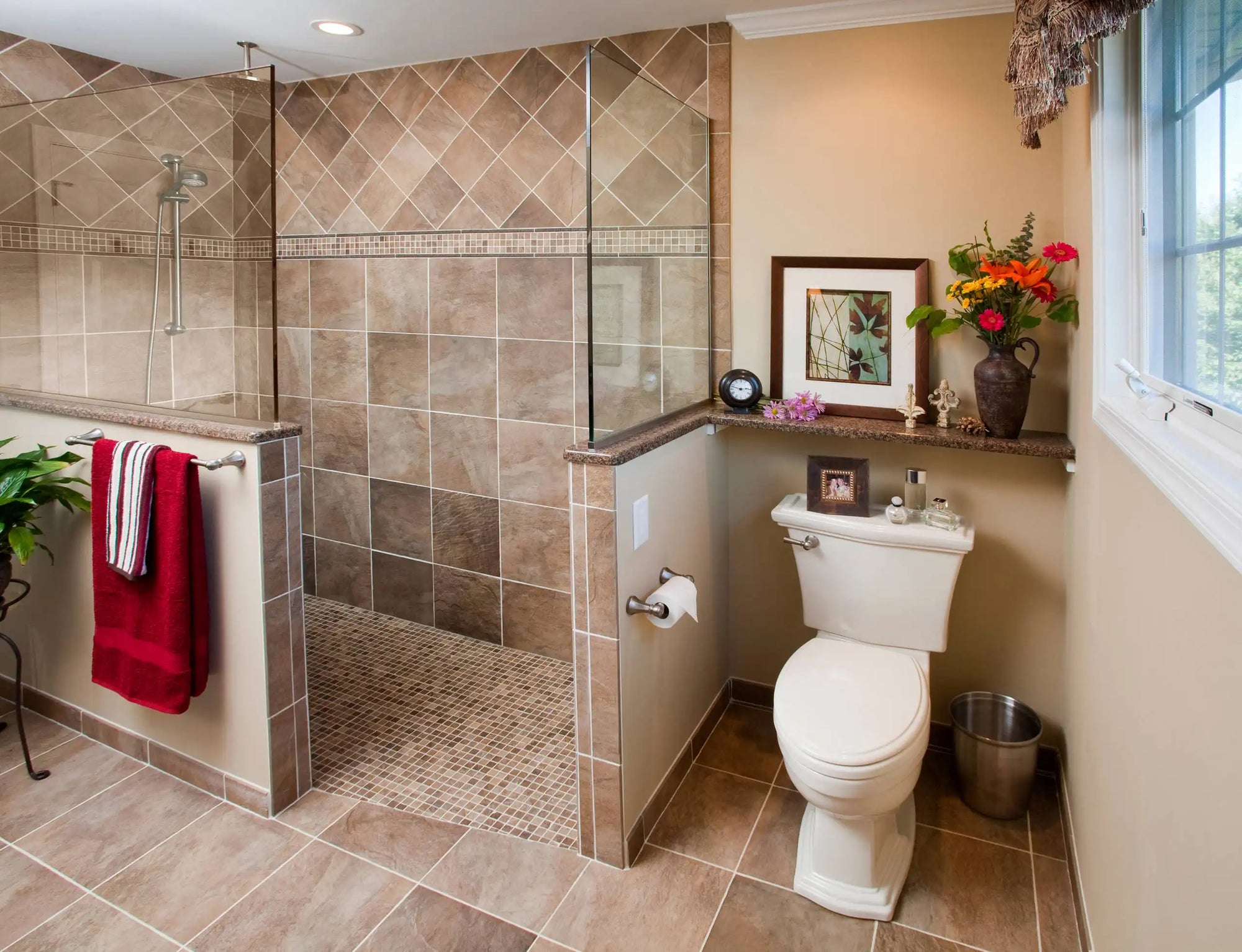 Warm-toned bathroom with built-in bench and tiled half wall shower no door enclosure.