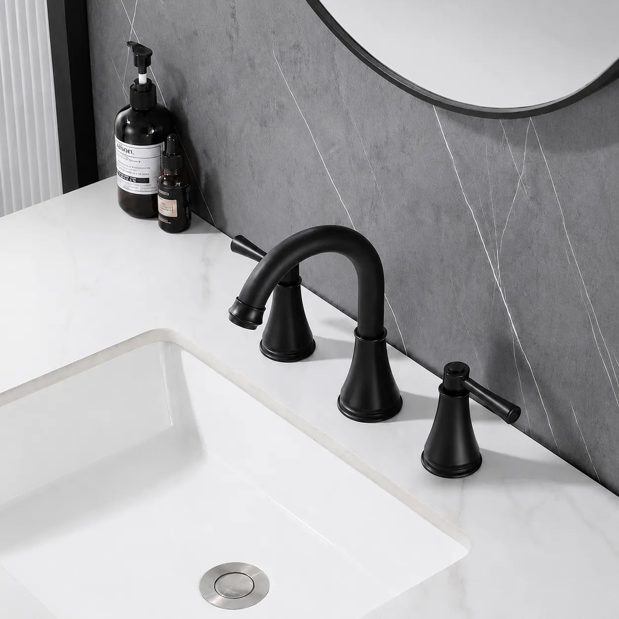 Top view of VALMIRA Matte Black Sink Faucet installed on marble vanity and gray wall backdrop.