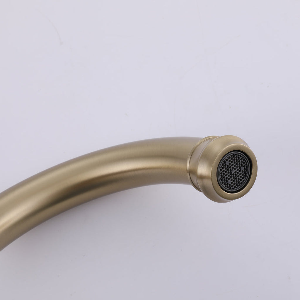 Close-up of VALMIRA brushed gold sink faucet with curved spout and detailed black spray face.