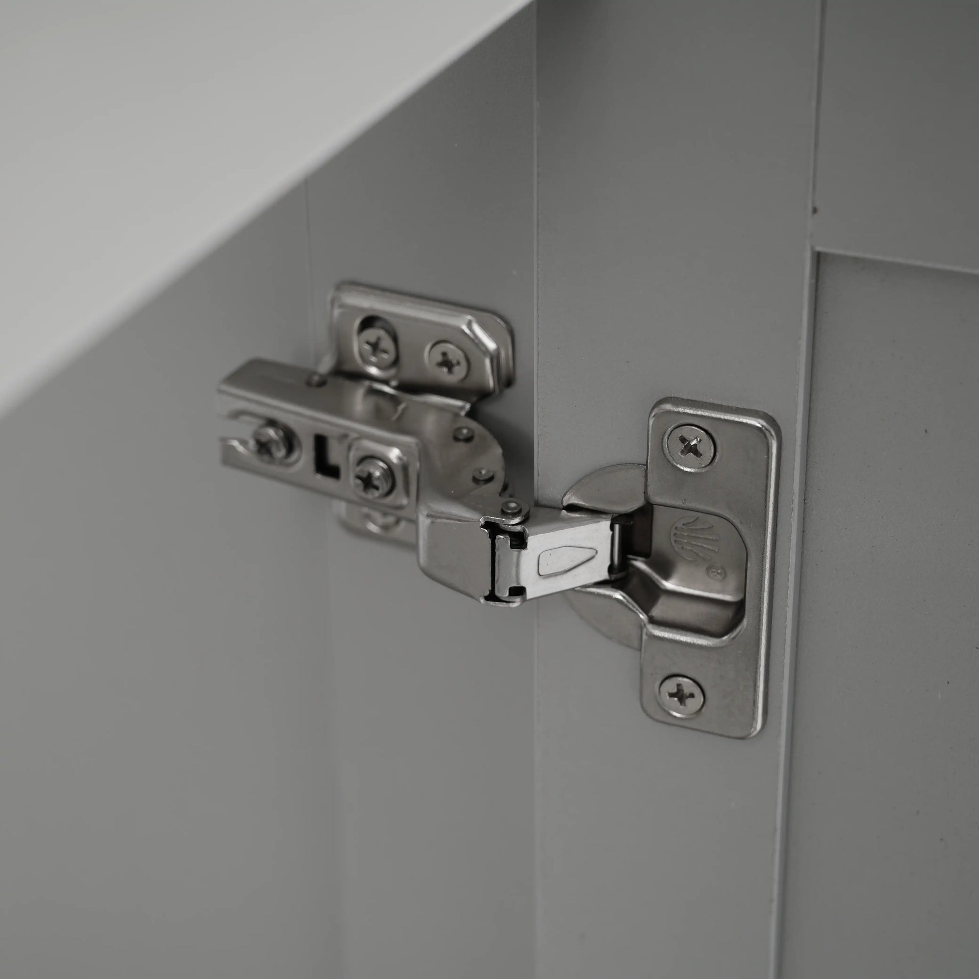 Soft close hinge detail on a gray bathroom vanity, ensuring smooth, quiet, and safe cabinet door operation | Ace Decor