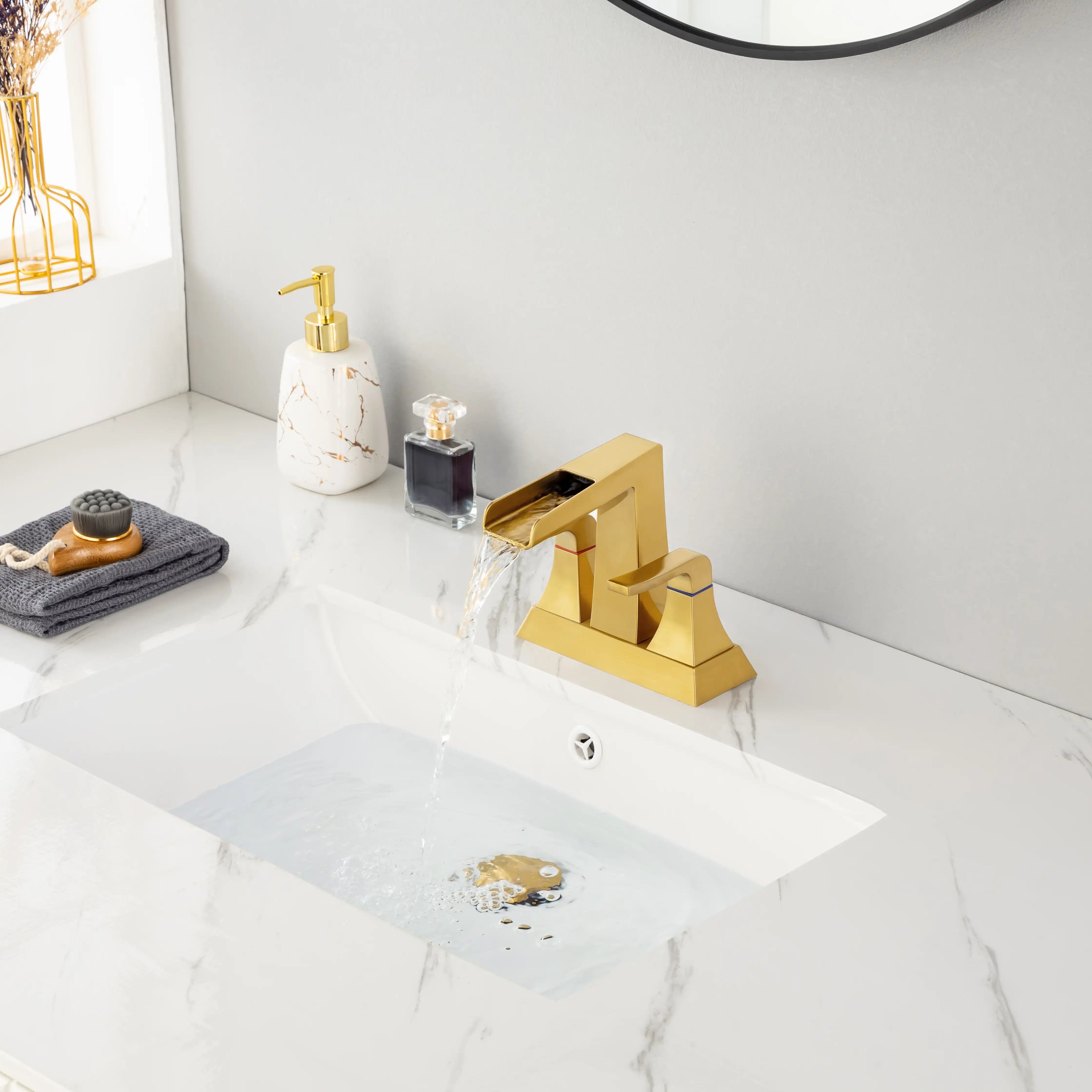 Aurora Series widespread brushed gold bathroom faucet filling sink with steady water flow