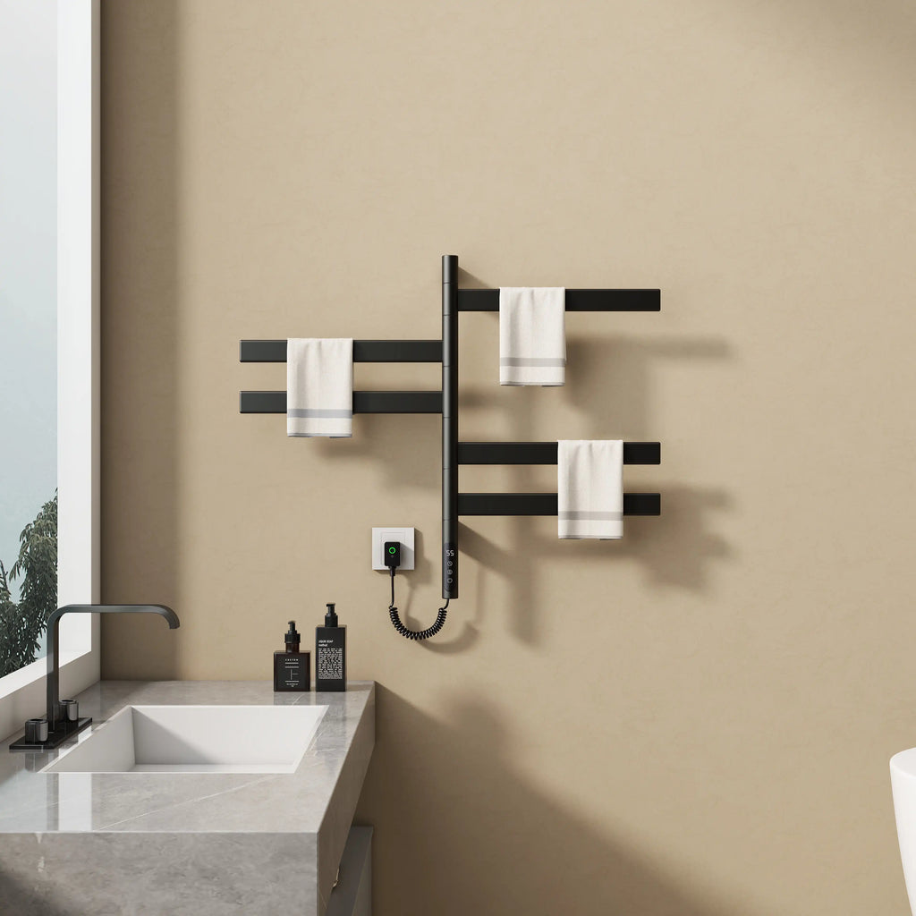 Velin Series 18 x 27 black electric towel warmer for bathroom mounted near sink with towels displayed on rotating bars.