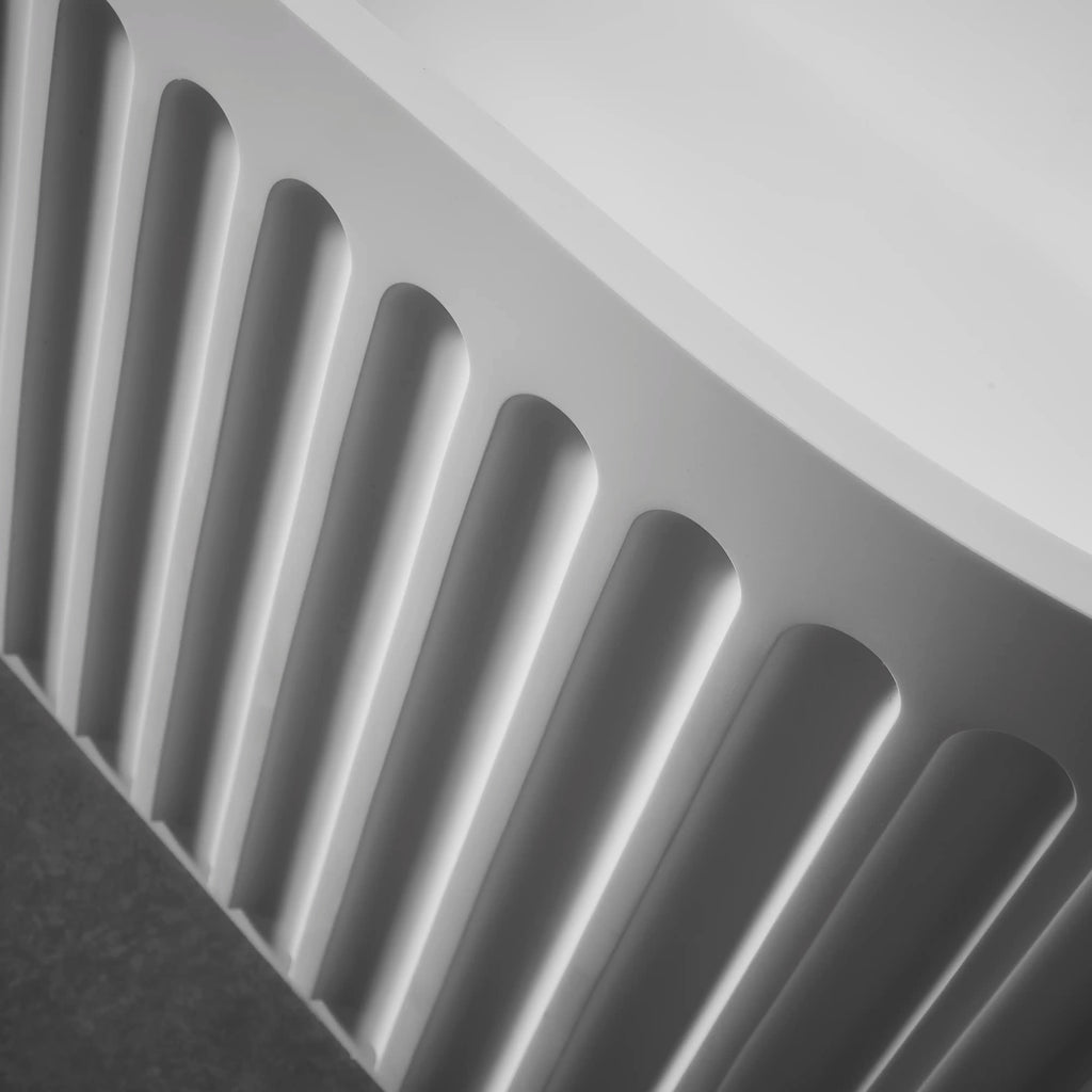 Close-up view of the fluted exterior design on Nectar Series 67 inch modern solid surface freestanding bathtub.