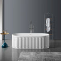 Nectar Series 67-inch solid surface freestanding soaking bathtub in modern bathroom with oval design and vertical ribs.