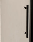 Close-up of Brivio matte black sliding shower door with sleek stainless steel handle.