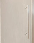 Close-up of Brivio chrome sliding shower door with sleek stainless steel handle.