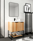 Striata freestanding 30-inch bathroom vanity in a modern bathroom with black frame mirror and fixtures.