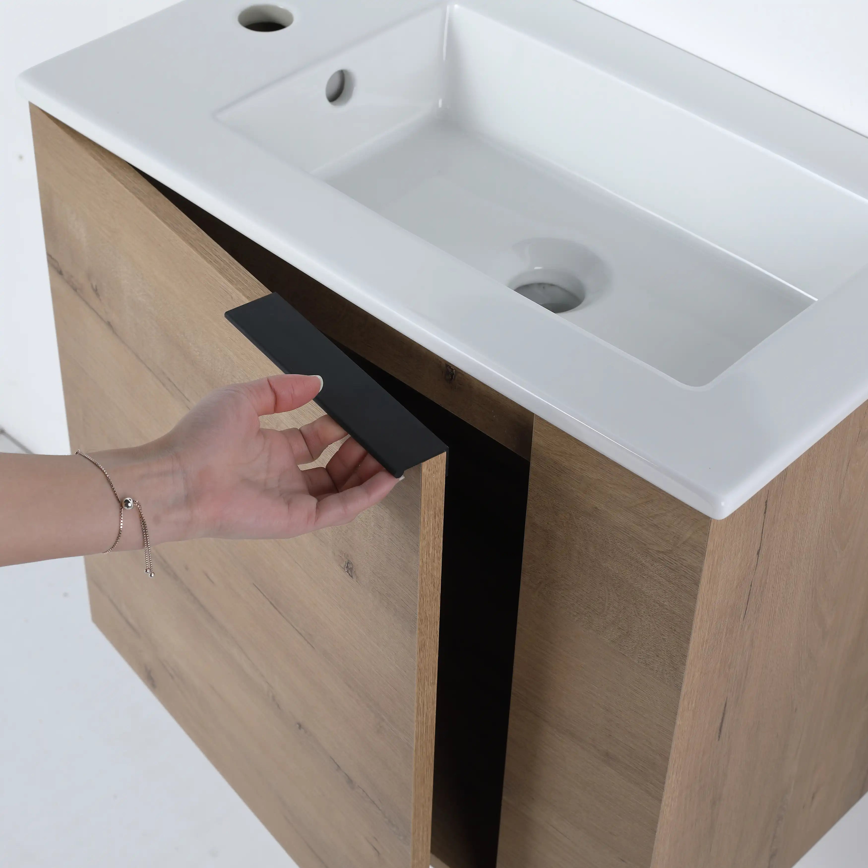 22 inch oak wood bathroom vanity with matte black pull handle detail.