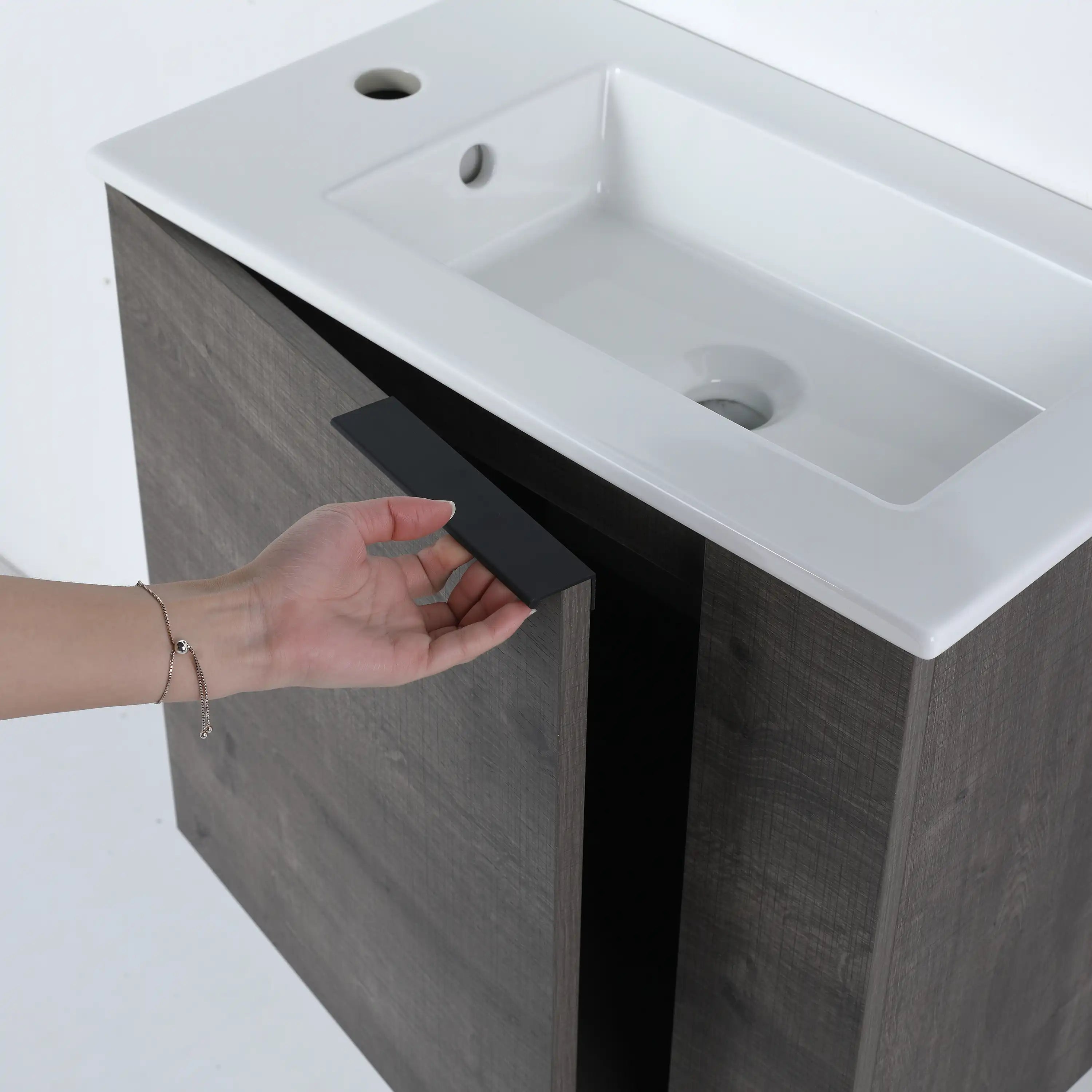 Metal black handle and grey cabient door detail on the Forma Series bathroom vanity.