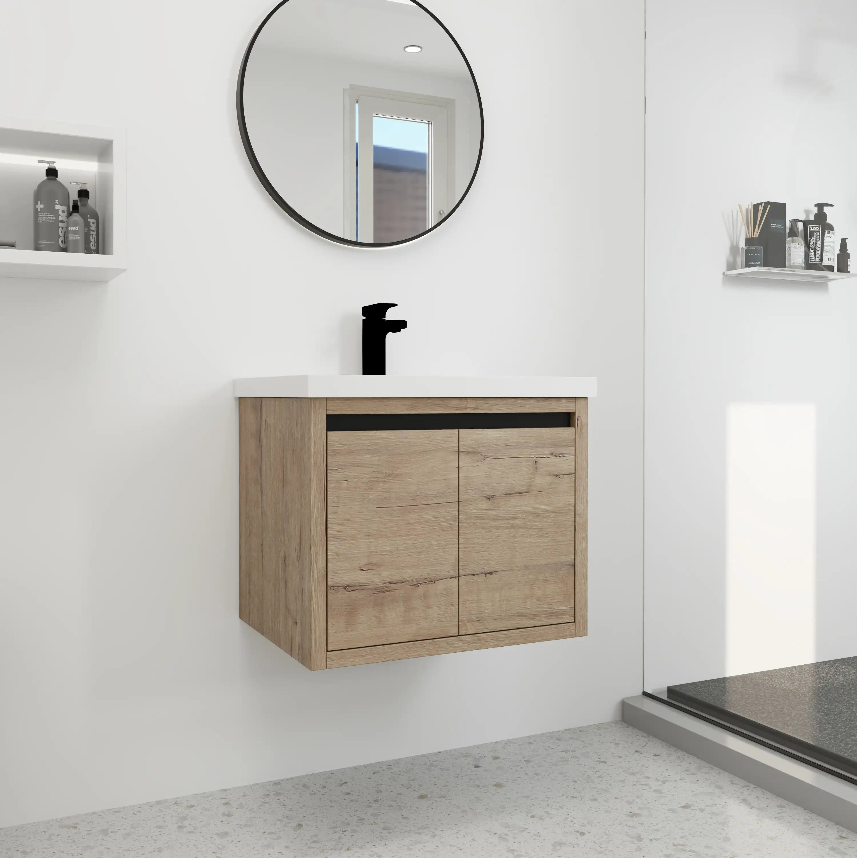 Walden 24 inch bathroom vanity installed in modern bathroom with black faucet and rounded mirror.