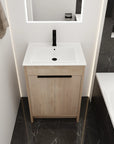 Front bathroom view of 24" light oak 24in bathroom vanity with white integrated sink and matte black faucet | Ace Decor