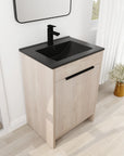 Angled view of freestanding 24 inch bathroom vanity with black integrated sink and light oak cabinet, 24" | Ace Decor