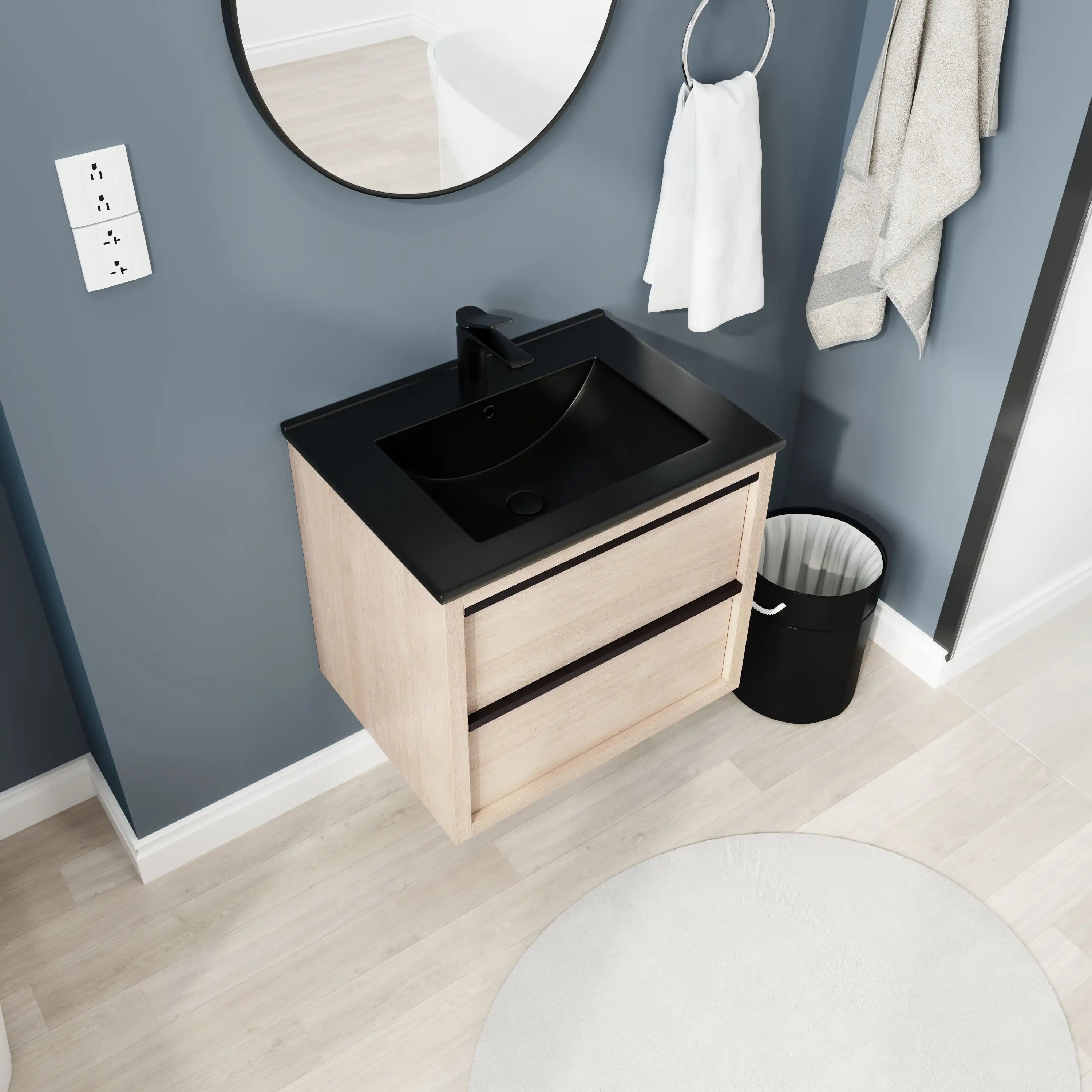 24" wall mounted bathroom vanity angled view with black ceramic sink and light oak cabinet.