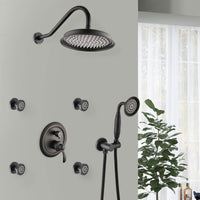 Avelar 9" matte black rain shower set with 4 body jets and hand shower installed in a modern bathroom setting.