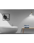 Noir Series black rectangular beveled-edge mirror reflecting a minimalist bathroom scene with a bathtub, artwork, and towel.